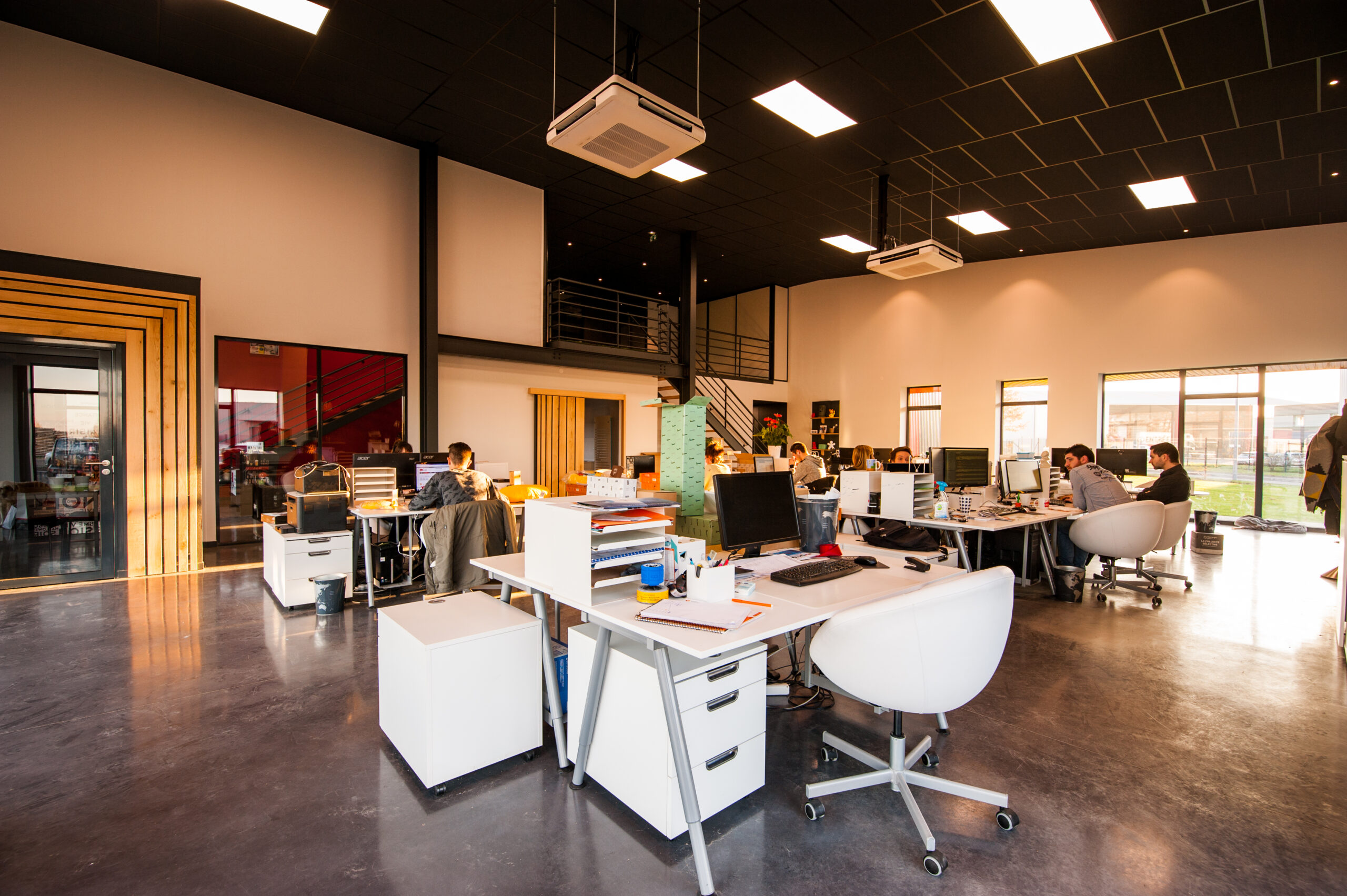 People sitting on chairs beside their desks in an office